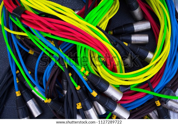 colorful sound and light signal cables on black\
stage case, shallow\
focus