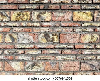 A Colorful Southwest Style Garden Wall With Red And Yellow Color Pattern