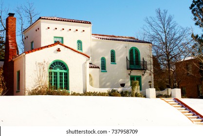 Colorful Southwestern House On Hill In The Snow With Steps Leading Up To It