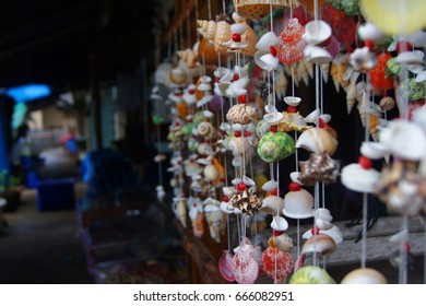 Colorful souvenirs made of sea shells being sold at floating town in the sea in Thailand.  - Shutterstock ID 666082951
