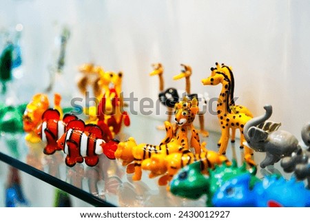 Colorful souvenirs from the world-famous Murano glass. Traditional Murano glass animal figures in branded gift shop, Murano island, Venice, Italy.