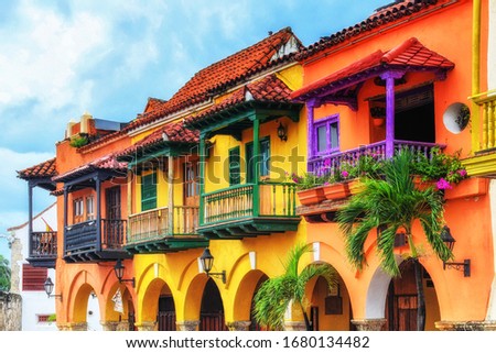 Colorful spanish colonial buildings with wooden balconies at Plaza de los Coches inside the walled city of Cartagena de Indias, Colombia. UNESCO world heritage site.