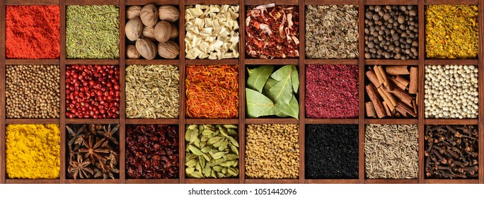 Colorful spice collage background. Assortment of condiments in wooden box top view.