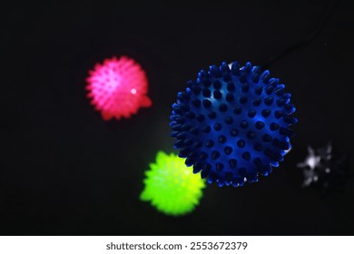 Colorful Spiky Light Balls on Black Background - Neon Glow and Abstract Shapes - Powered by Shutterstock