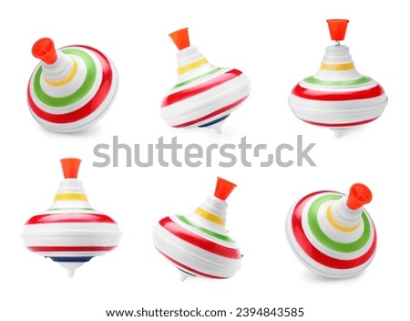 Colorful spinning tops isolated on white. Toy whirligig