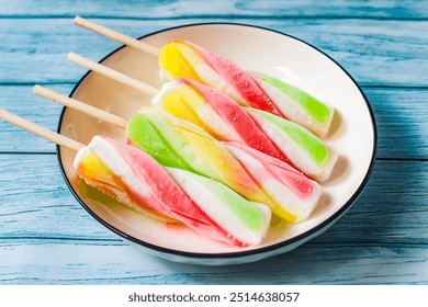 colorful spiral popsicles in a plate - Powered by Shutterstock