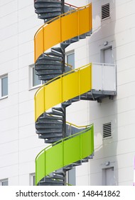 Colorful Spiral Staircase Against A Large Warehouse