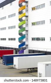 Colorful Spiral Staircase Against A Large Warehouse