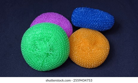 Colorful sponges on a black background - Powered by Shutterstock