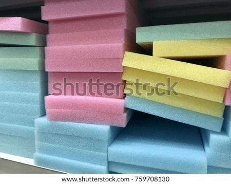 A lot of colorful sponges are placed on the stalls in the mall.
