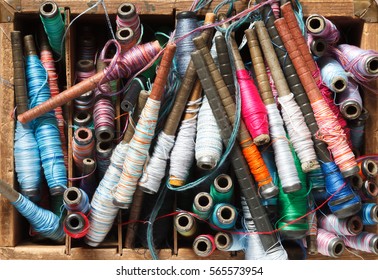 Colorful spools with threads for loom background.