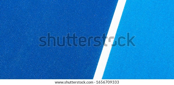 Colorful sports\
court background. Top view light blue and navy blue field rubber\
ground with white line\
outdoors