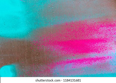 Colorful spray paint splatters on the wall, detailed close up texture background