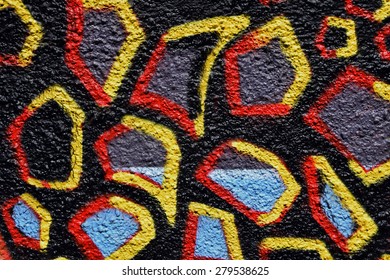 Colorful spray painted shapes on black textured wall abstract background.