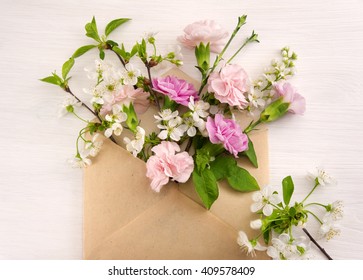 Colorful spring flowers in envelope, flower delivery concept