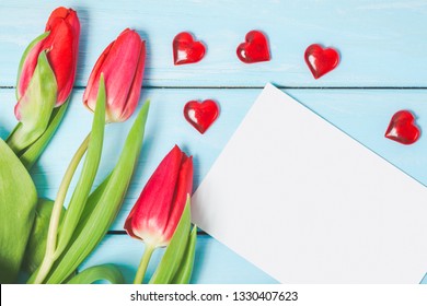 Colorful Spring Tulip Flowers With Blank Photo And Decorative Red Hearts On Light Blue Wooden Background As Greeting Card. Mothersday, Love Or Spring Concept.