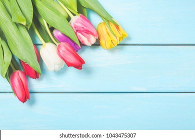 Colorful Spring Tulip Flowers On Light Blue Wooden Background As Greeting Card With Free Space. Mothersday Or Spring Concept.