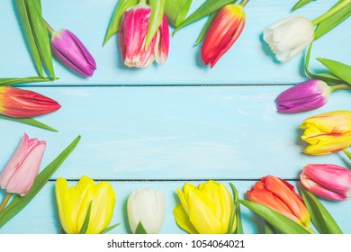 Colorful Spring Tulip Flowers On Light Blue Wooden Background As Greeting Card With Free Space. Mothersday Or Spring Concept.