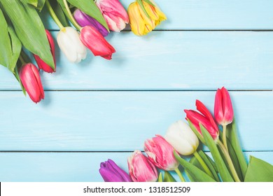 Colorful Spring Tulip Flowers On Light Blue Wooden Background As Greeting Card With Free Space. Mothersday Or Spring Concept.