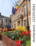 Colorful springtime view of the ephemeral gardens and 18th century town hall of Boulogne-sur-Mer, on the beautiful Opal Coast of Northern France. Spring bulbs flowering in the foreground.