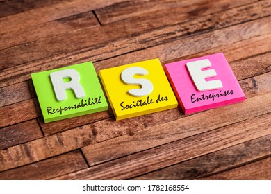 Colorful square papers with wooden white letters for the French acronym means Corporate Social Responsibility - Shutterstock ID 1782168554