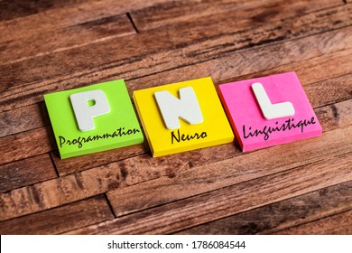 Colorful square papers with wooden white letters for the French acronym word PNL means NLP Neuro Linguistic Programming - Shutterstock ID 1786084544