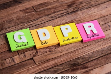 Colorful square papers with wooden white letters for the acronym word GDPR - Shutterstock ID 1836541063