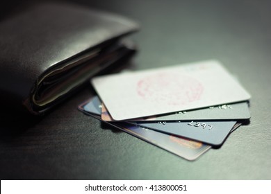 Colorful Stack Of Credit Cards And Shopping Gift Cards  With Wallet On Gray Carpet Back Ground. Extremely Shallow Dof.