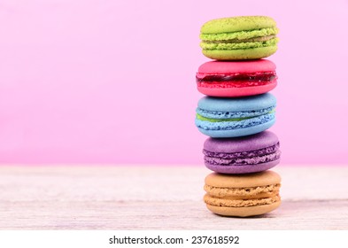 colorful stack of macaron on white wood table