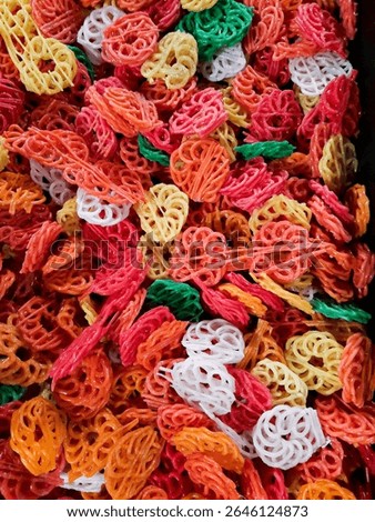 A colorful stack of raw crackers, waiting to be fried into crispy delights.