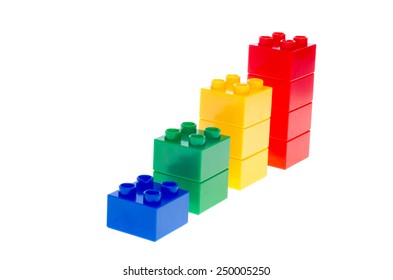 Colorful stacked toy plastic building blocks isolated on white background
