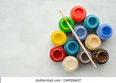Colorful stained glass or oil, acrylic paints with paint brush  on gray background with copy space, top view.  - Shutterstock ID 1349104637