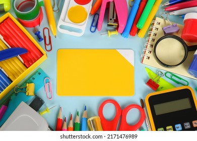 A lot of colorful stationery, in the center is an empty card template on a blue background.Purchases of office supplies online through online stores, discounts and promotions on school supplies