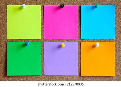 colorful sticky notes on cork bulletin board - Shutterstock ID 212578036