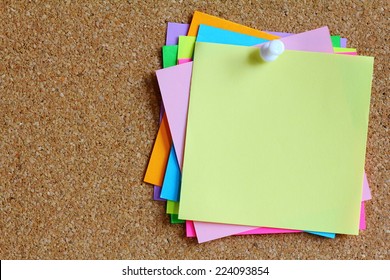 colorful sticky notes on cork bulletin board