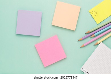 Colorful sticky notes and colorful pencils on color background.Back to school concept.Copy space for your text message or media and content.Top view image.Many different empty colorful  notes. 