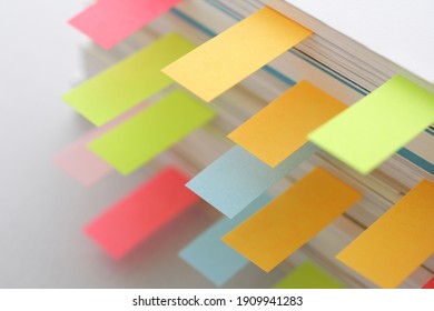 Colorful sticky notes sandwiched between books  - Shutterstock ID 1909941283