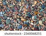 Colorful stones on the shore of Waterton Lake in Waterton Lakes National Park, Alberta, Canada