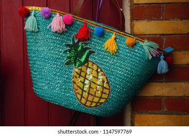 Colorful straw beach bag with pineapple and tassels