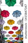 colorful street art umbrellas in dublin hanging in pattern above street in temple bar destrict - symbol for joy and fun