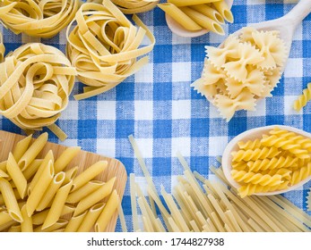 Colorful and stylist composition. Cooking and Italian foods concept. Mixed dried pasta selection on blue and white linen towel as background. Flat lay top view with copyspace for text, logo or other. - Shutterstock ID 1744827938