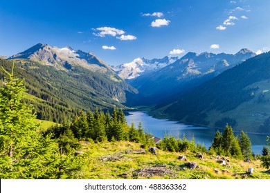 Colorful summer morning on the Speicher Durlassboden lake. View of Richterspitze mountain range in the Austrian Alps. Austria, Europe.