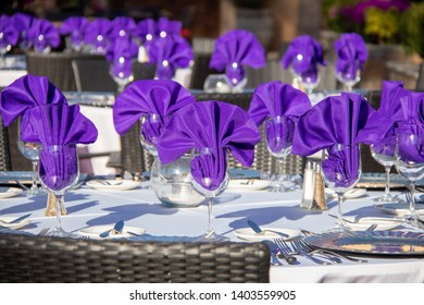 A Colorful Summer Place Setting With Purple Napkins