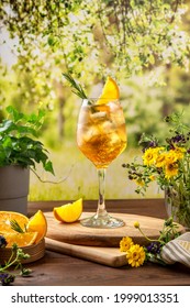 Colorful Summer Sparkling Cocktail On The Table. Hard Seltzer Cocktail With Orange. Summer Party Table Outdoor In A House Backyard With сold Summer Drink. 