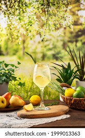 Colorful Summer Sparkling Cocktail On The Table. Hard Seltzer Cocktail With Lemon. Summer Party Table Outdoor In A House Backyard With сold Summer Drink.