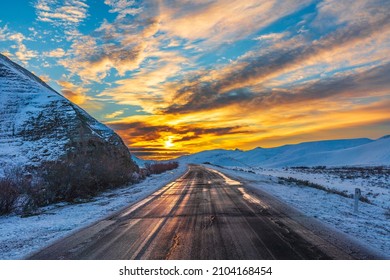 Colorful sunrise on a mountain road in winter