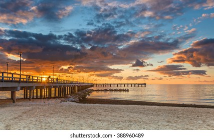 Colorful sunset at a famous marine berth in resort city of Palanga, Baltic Sea, Lithuania, Europe
