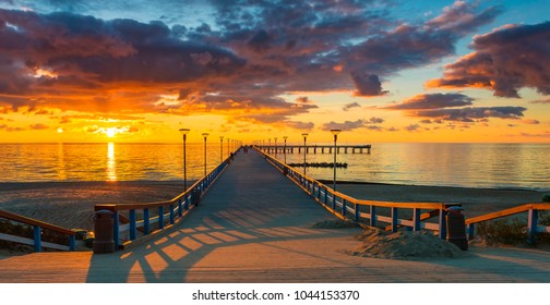 Colorful sunset at a famous marine pier in the Baltic resort city of Palanga, Lithuania, Europe