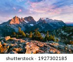 A Colorful Sunset Illuminates the Peaks of Summit Chief Mountain, Chimney Rock, Overcoat Peak and Snoqualmie Mountain Near Tank Lakes. Alpine Lakes Wilderness, Washington.