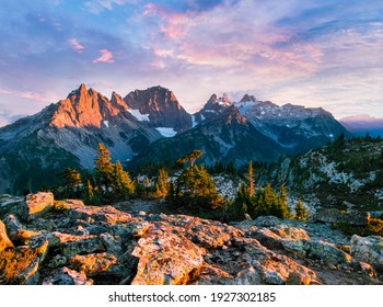 A Colorful Sunset Illuminates the Peaks of Summit Chief Mountain, Chimney Rock, Overcoat Peak and Snoqualmie Mountain Near Tank Lakes. Alpine Lakes Wilderness, Washington.